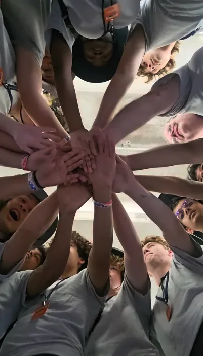 Hands-in team huddle